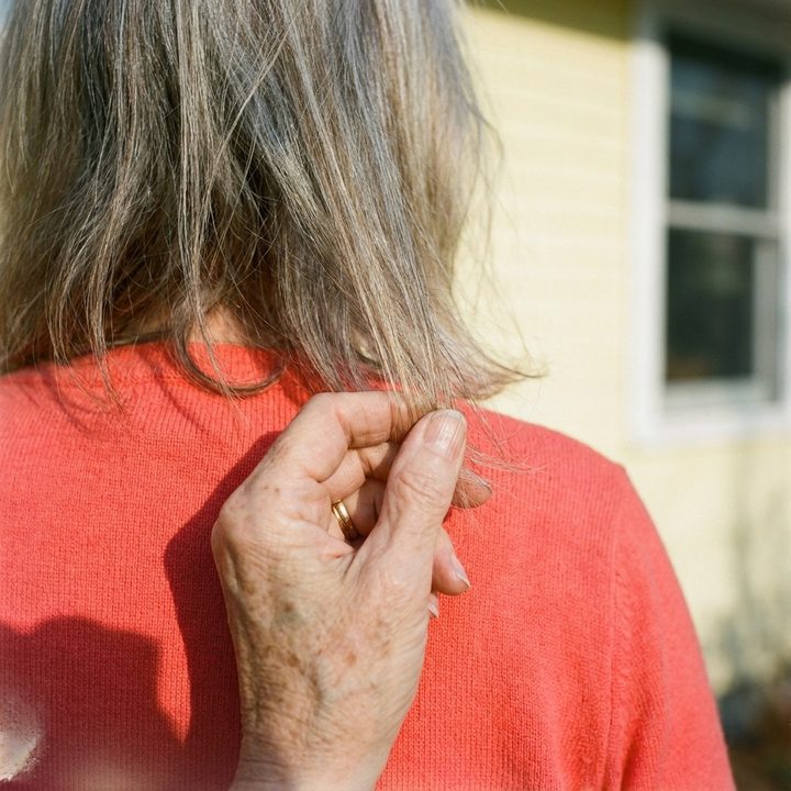 Thin, wispy hair ends against a coral cardigan